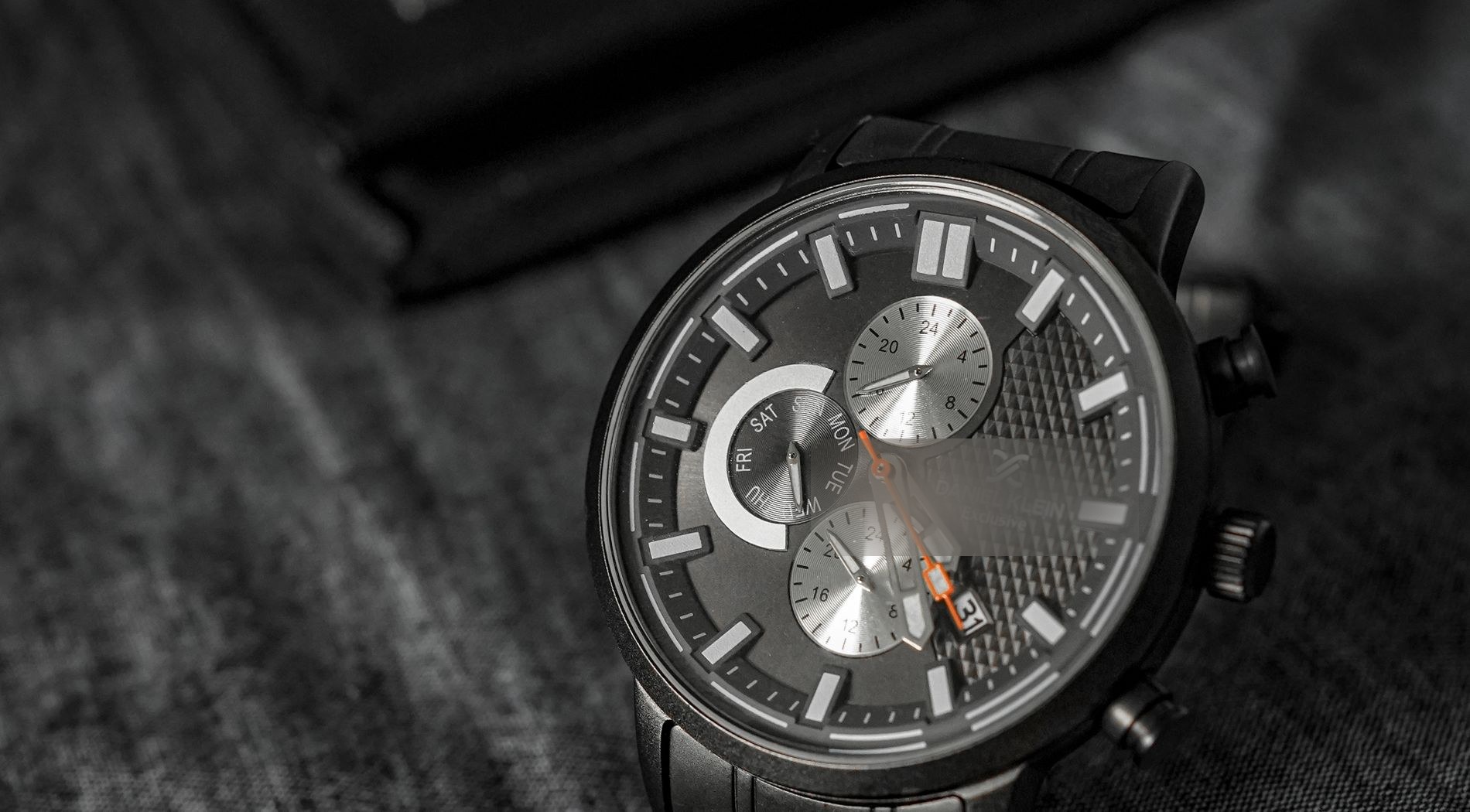 Black chronograph on a dark surface